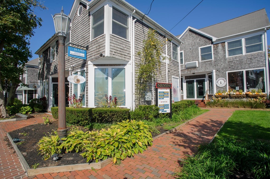 15 Winter Street, Unit 9 Edgartown, MA 02539 - Photo 11 of 13 a front view of a house with garden and porch