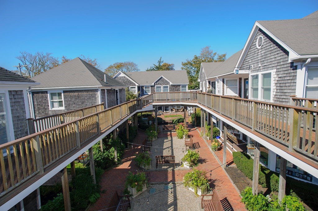 15 Winter Street, Unit 9 Edgartown, MA 02539 - Photo 12 of 13 a front view of house with deck and outdoor seating