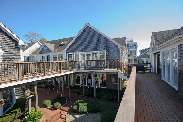 a view of a house with wooden deck