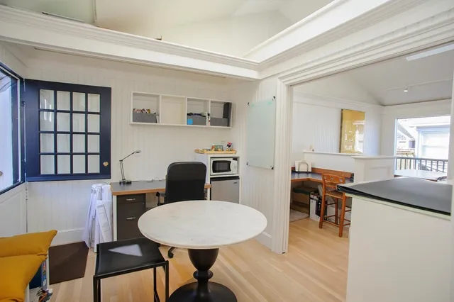 a view of a dining room with furniture and window