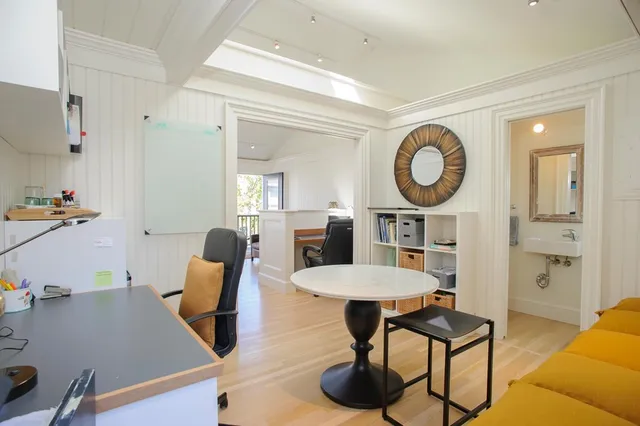 a living room with furniture and a clock