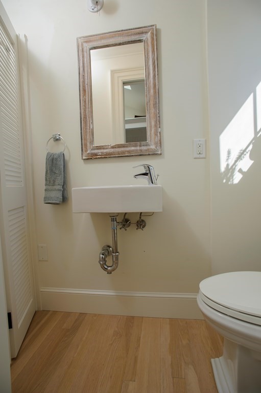 15 Winter Street, Unit 9 Edgartown, MA 02539 - Photo 10 of 13 a bathroom with a toilet sink and mirror