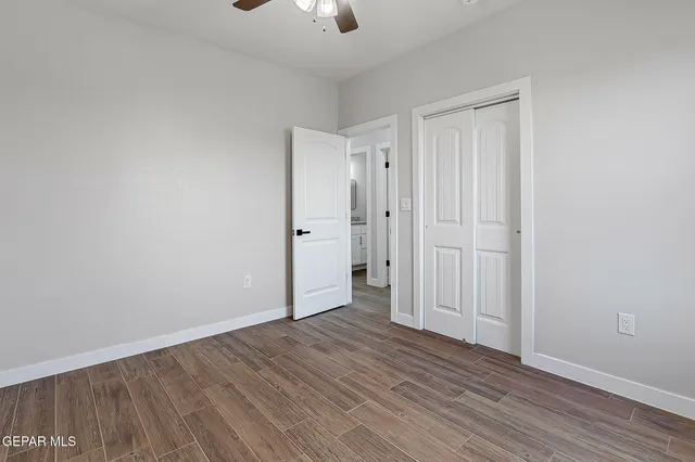 a view of an empty room with wooden floor