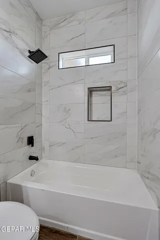 a bathroom with a bathtub and a shower