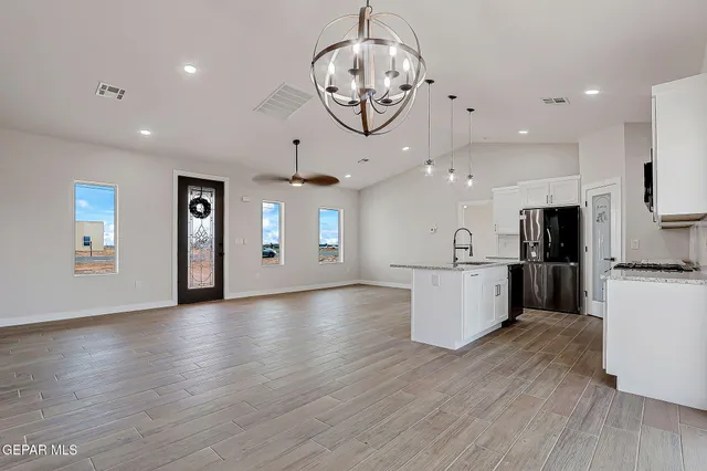 a view of a kitchen with stove and cabinets