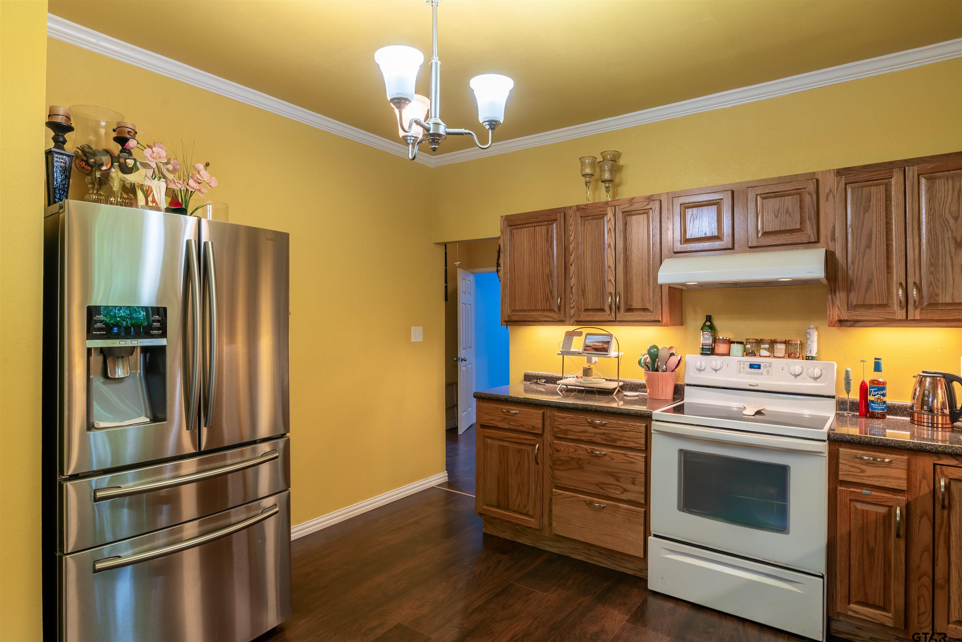 427 East Locust Street Tyler, TX 75702 - Photo 11 of 42 a kitchen with stainless steel appliances a stove a refrigerator and a sink