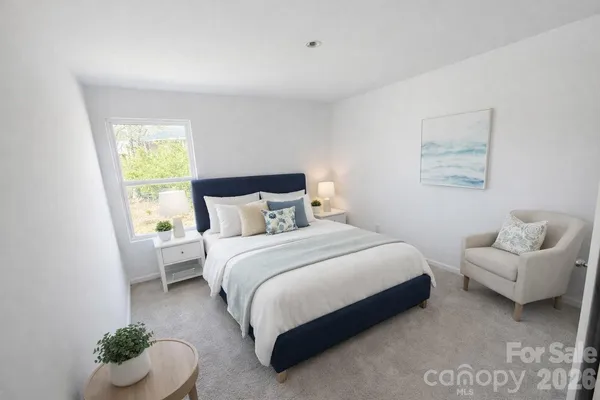 a bedroom with a bed and a couch