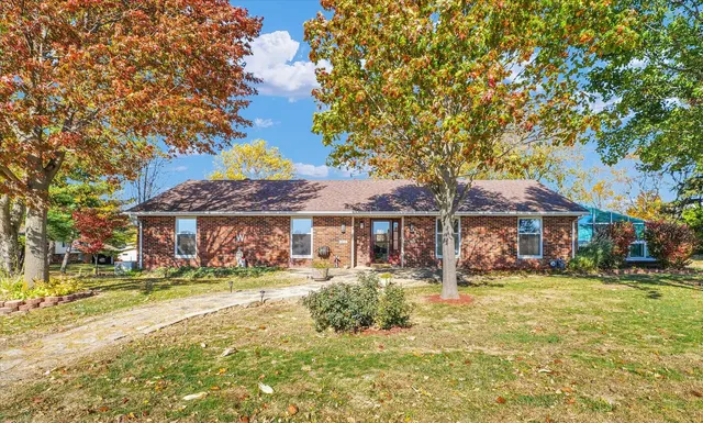a front view of a building with a garden