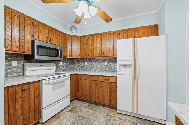 a kitchen with stainless steel appliances granite countertop a refrigerator and microwave