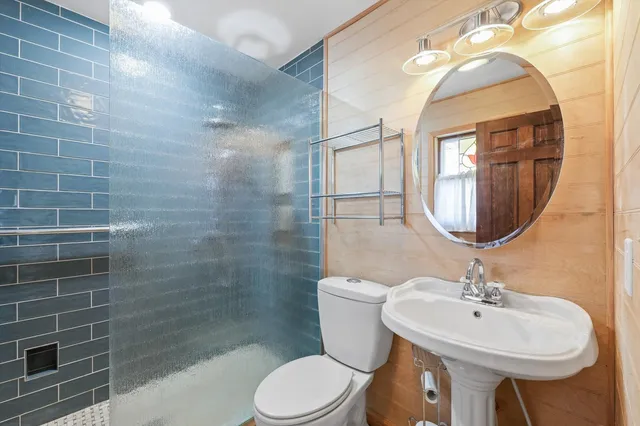 a bathroom with a sink a mirror and a toilet