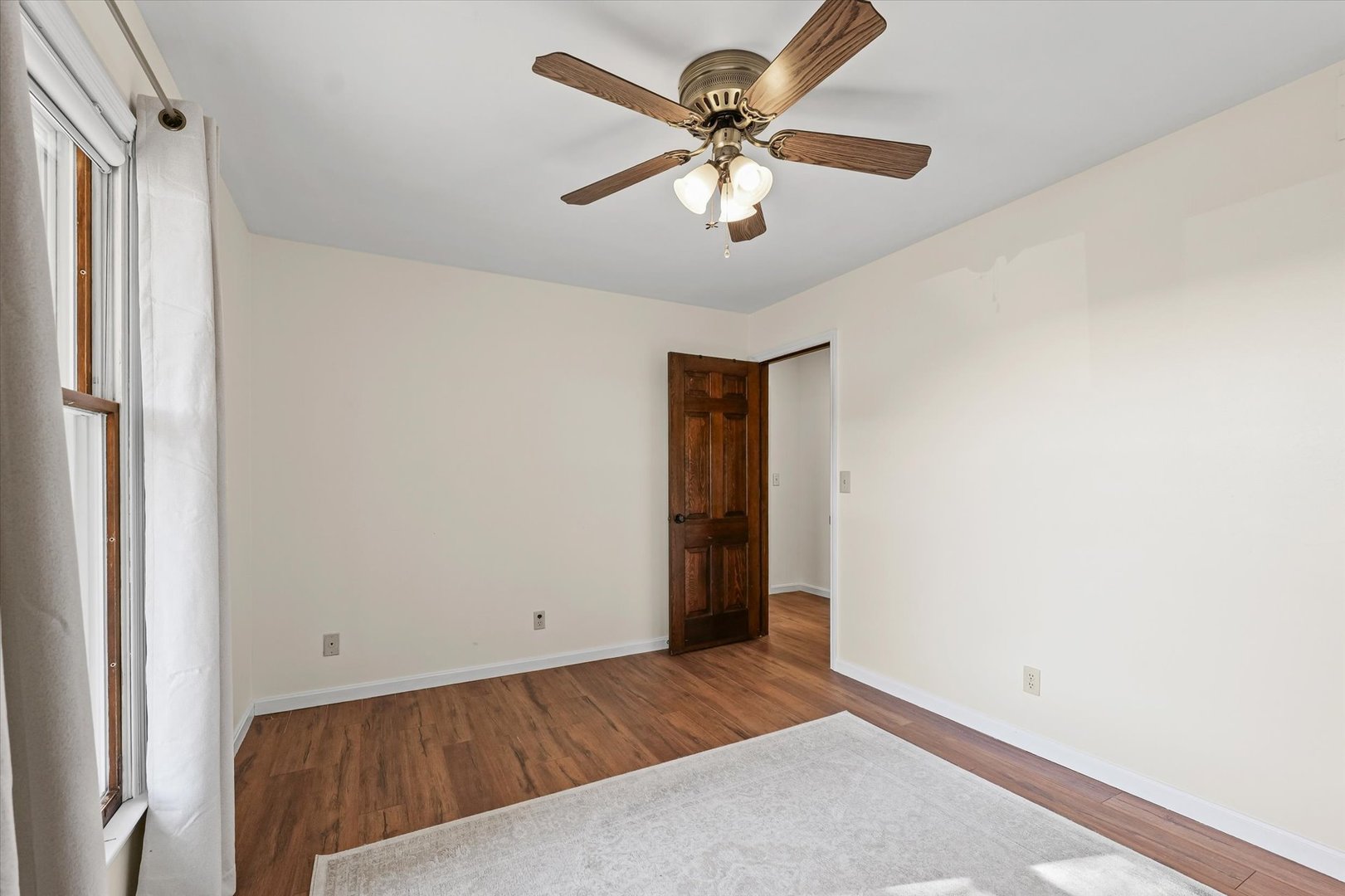 1000 East Kratz Road Monticello, IL 61856 - Photo 30 of 52 a view of a livingroom with a ceiling fan and wooden floor