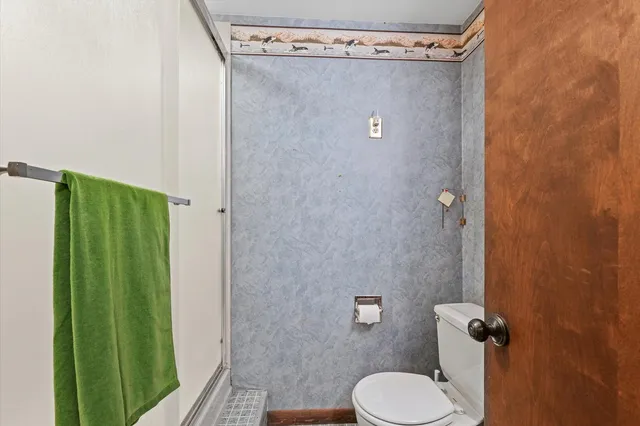 a bathroom with a toilet and a shower