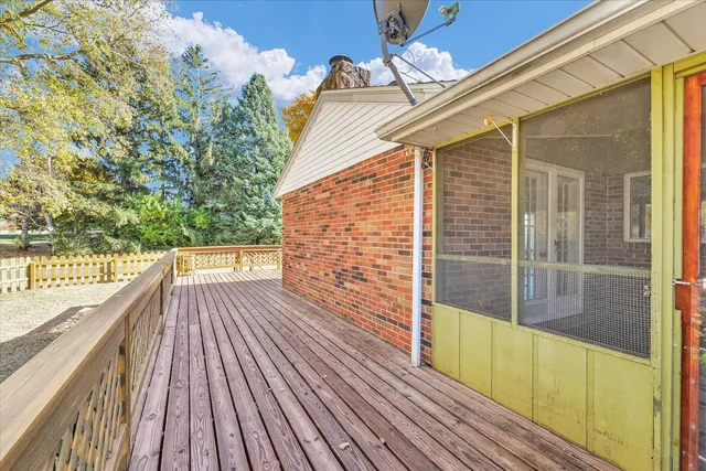 a view of a house with a wooden fence