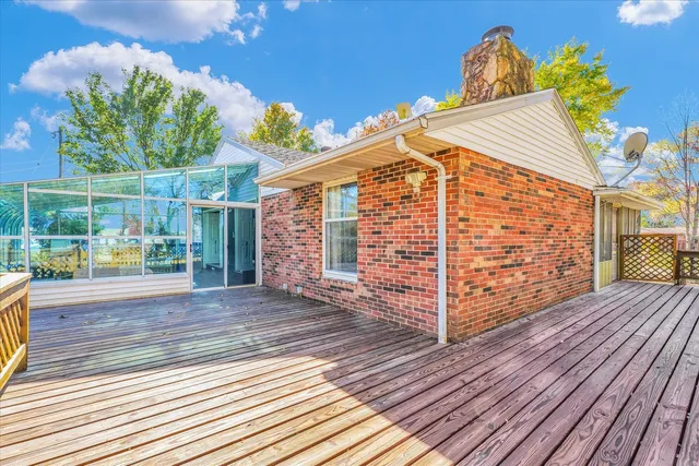 a view of a porch with furniture and a yard