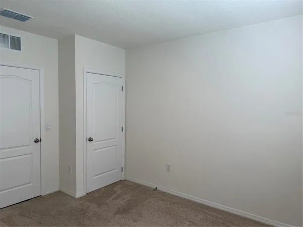 a kitchen with refrigerator and microwave