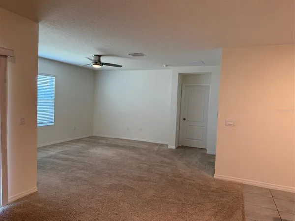 a large kitchen with a refrigerator a counter top space and a sink
