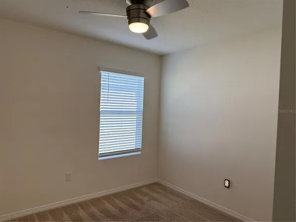 a bathroom with a granite countertop bathtub shower sink vanity and toilet