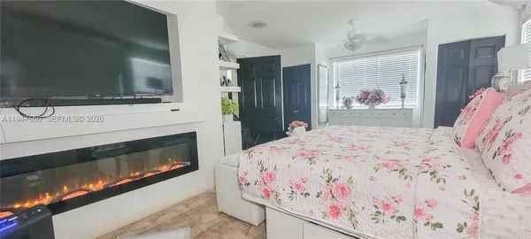 a bedroom with a bed and a television