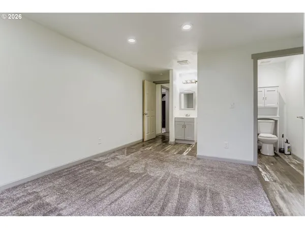 a view of an empty room and a bathroom