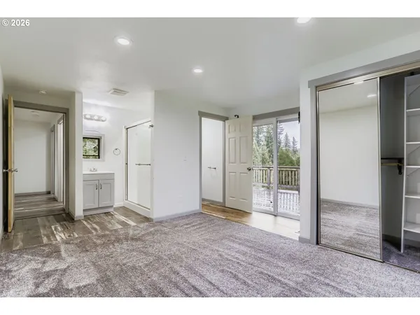 a view of an empty room and a bathroom