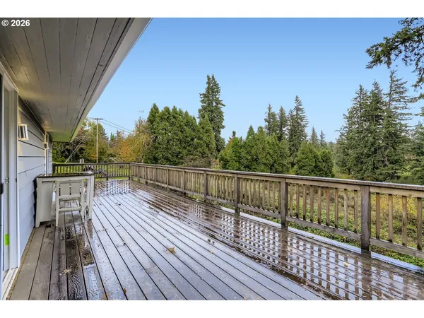 a view of balcony with wooden floor and fence