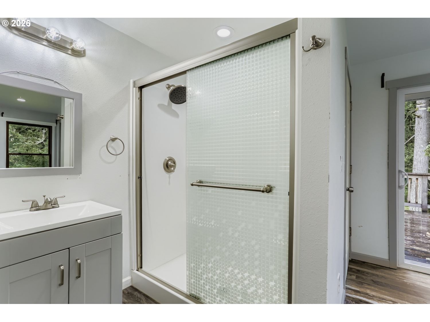 14661 Southeast Royer Road Damascus, OR 97089 - Photo 20 of 40 a bathroom with a shower sink and mirror