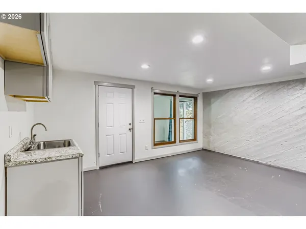 a view of an empty room with a kitchen