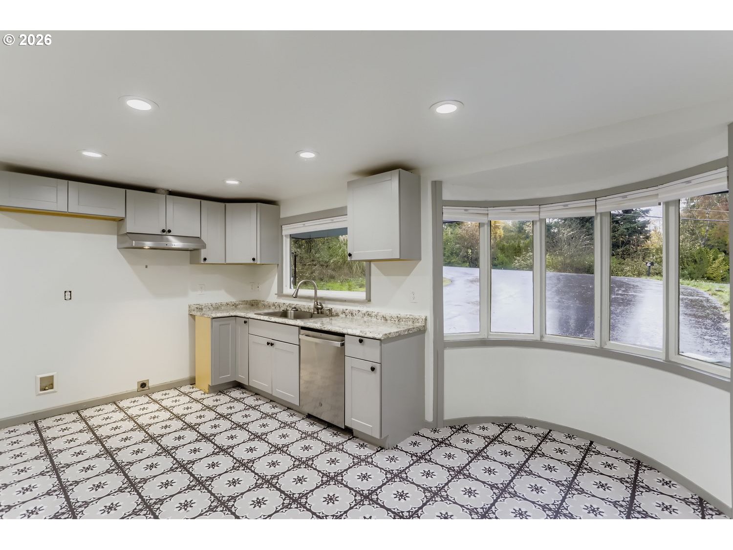 14661 Southeast Royer Road Damascus, OR 97089 - Photo 6 of 40 a kitchen with granite countertop a stove a sink and a refrigerator