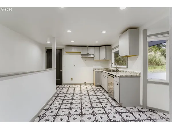 a kitchen with a sink a counter top space and appliances
