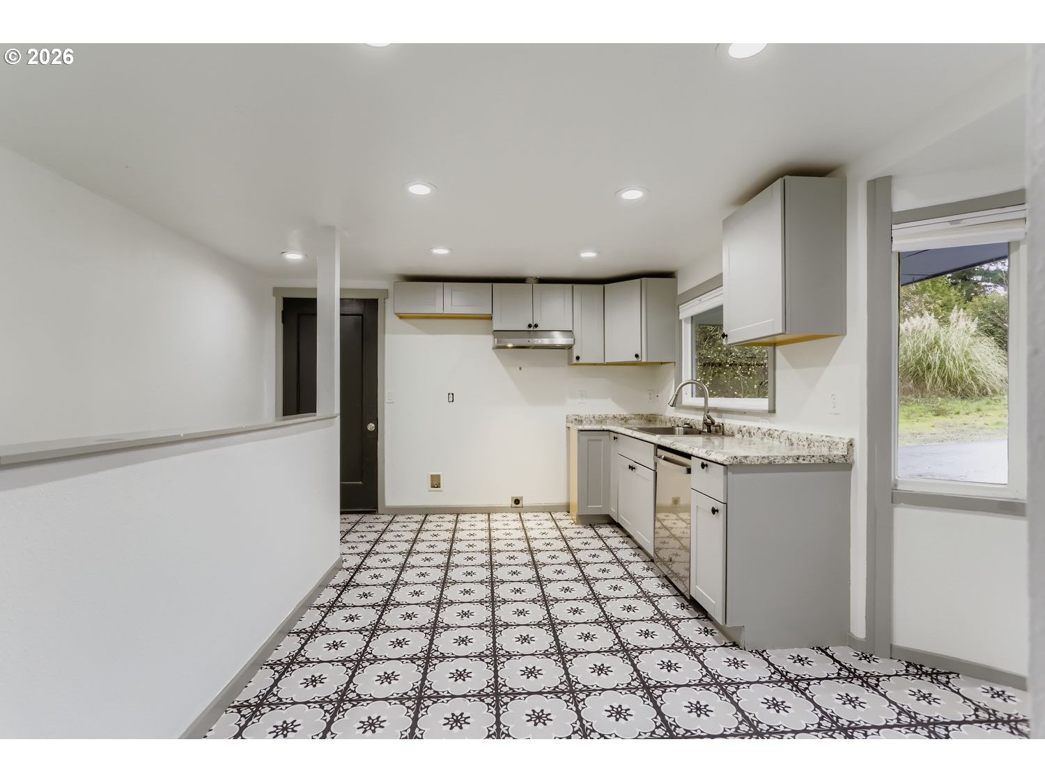 14661 Southeast Royer Road Damascus, OR 97089 - Photo 8 of 40 a kitchen with a sink a counter top space and appliances