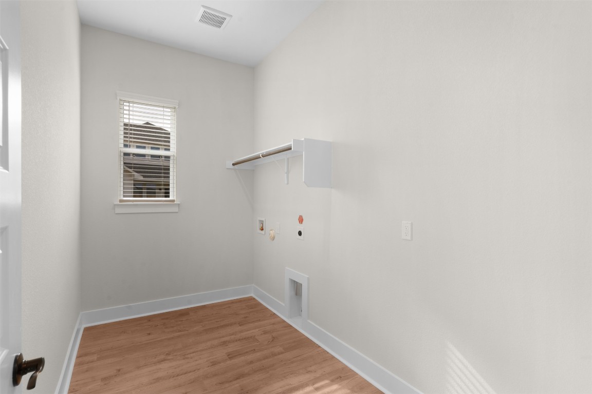 19513 Domino Champ Road Pflugerville, TX 78660 - Photo 12 of 28 a view of a small space with wooden floor and a window