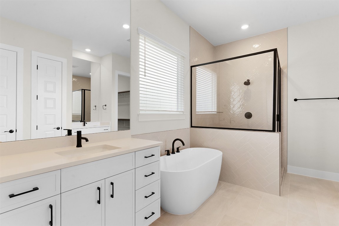 19513 Domino Champ Road Pflugerville, TX 78660 - Photo 14 of 28 a bathroom with double vanity sink and mirror