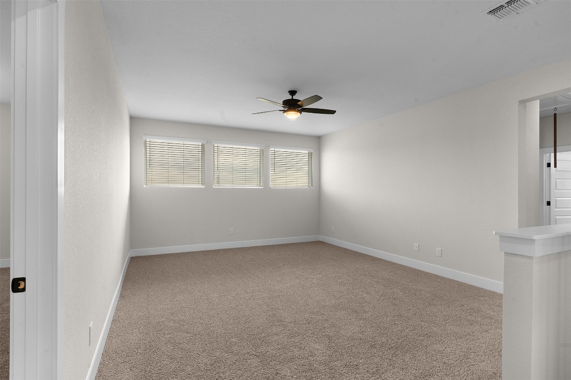 19513 Domino Champ Road Pflugerville, TX 78660 - Photo 16 of 28 an empty room with a window and a ceiling fan