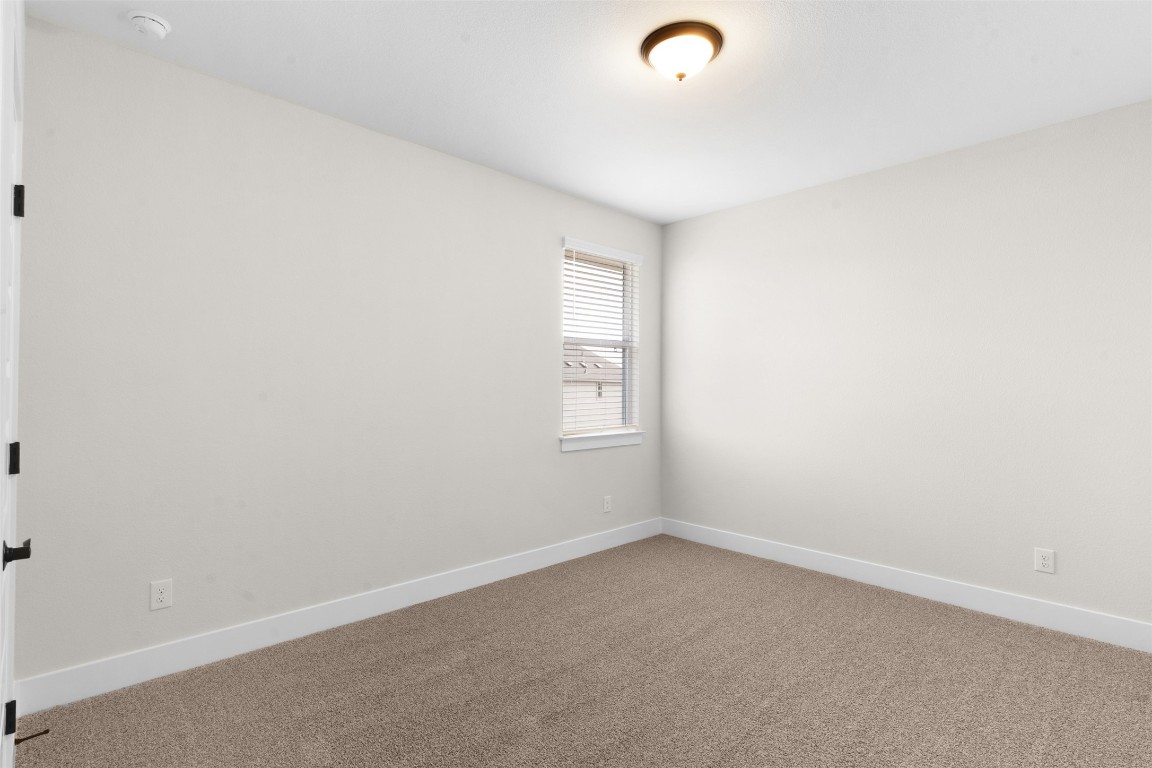19513 Domino Champ Road Pflugerville, TX 78660 - Photo 20 of 28 an empty room with a window