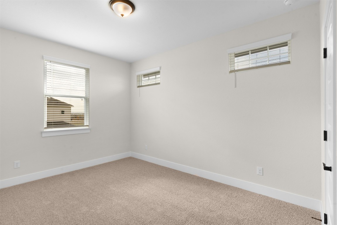 19513 Domino Champ Road Pflugerville, TX 78660 - Photo 21 of 28 an empty room with windows