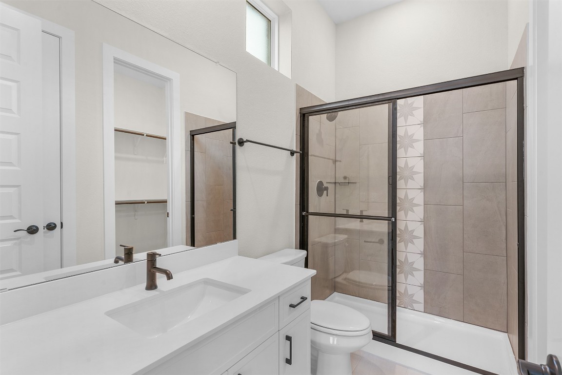 19513 Domino Champ Road Pflugerville, TX 78660 - Photo 5 of 28 a bathroom with a sink toilet and shower