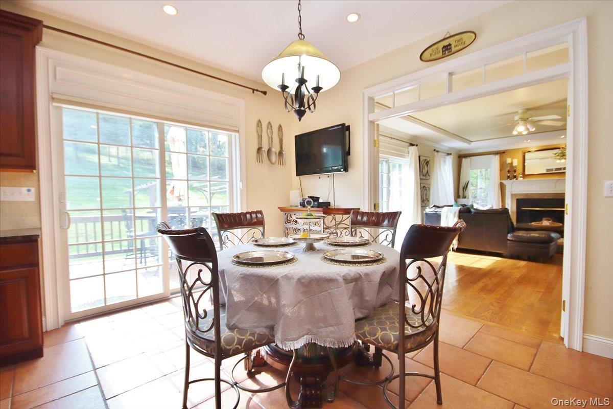 430 Eder Road Stormville, NY 12582 - Photo 23 of 50 a view of a dining room with furniture a chandelier and large windows