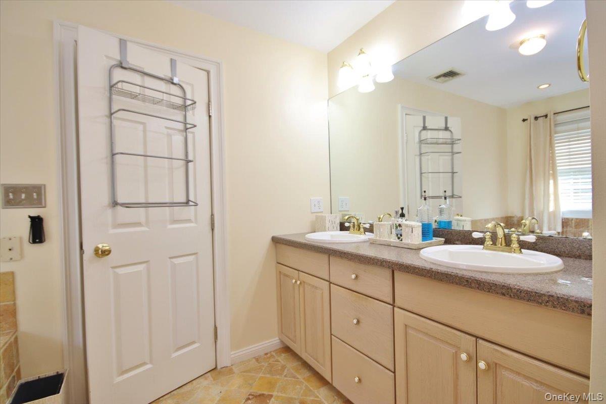 430 Eder Road Stormville, NY 12582 - Photo 32 of 50 a bathroom with a double vanity sink and mirror