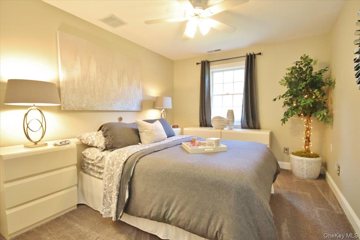 430 Eder Road Stormville, NY 12582 - Photo 37 of 50 a bed room with a bed and a potted plant