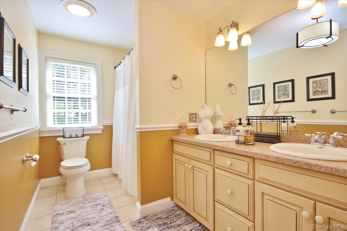 430 Eder Road Stormville, NY 12582 - Photo 38 of 50 a bathroom with a double vanity sink toilet and a tub