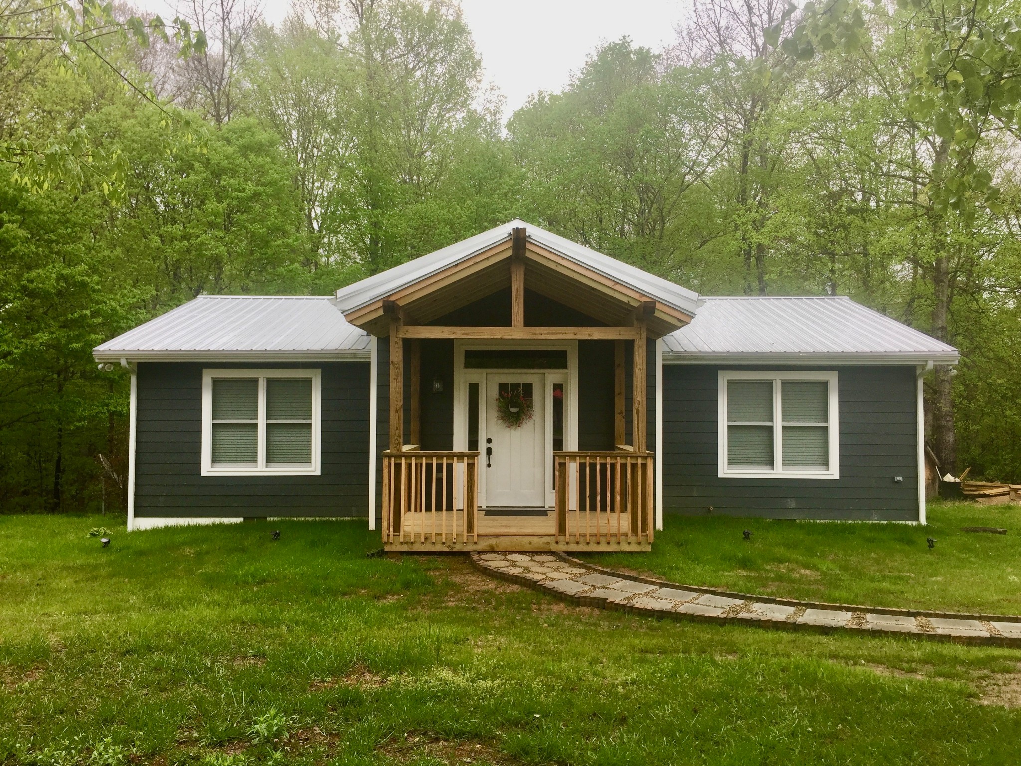 a front view of a house with a garden