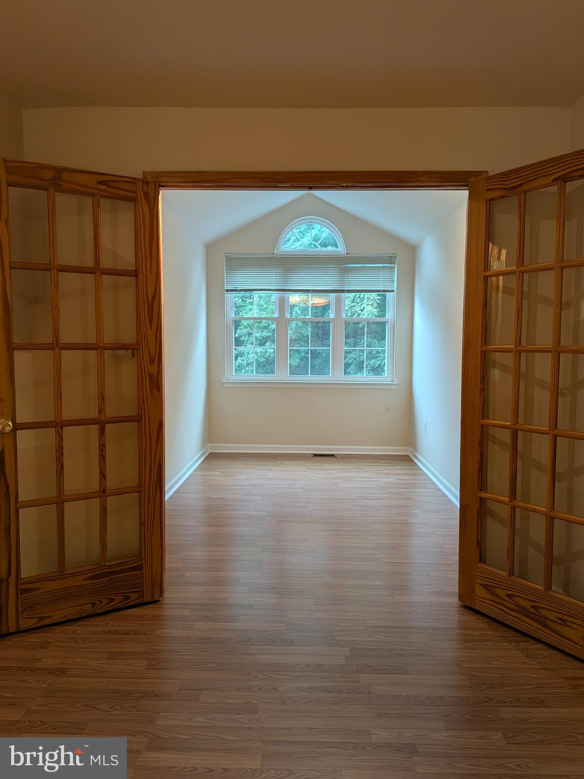 109 Timberbrook Lane, Unit 301 Gaithersburg, MD 20878 - Photo 5 of 22 an empty room with wooden floor and windows