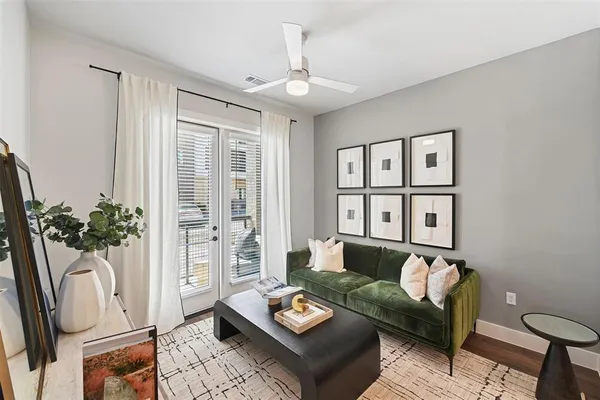 a living room with furniture and a potted plant