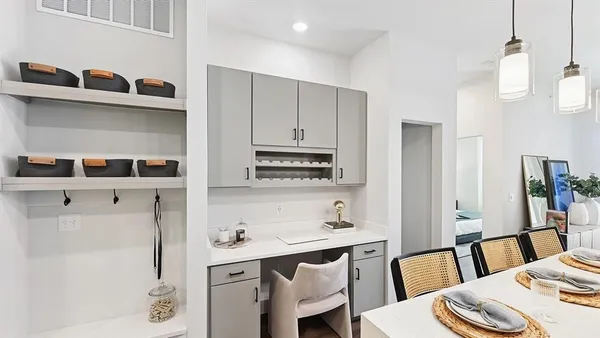 a kitchen with stainless steel appliances a white table and chairs in it