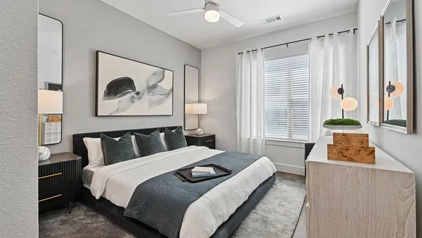 a bedroom with a bed and a painting on the wall