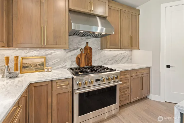 a kitchen with granite countertop a stove and a sink