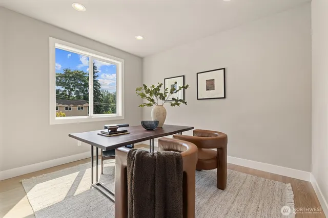 a view of a workspace with furniture and window