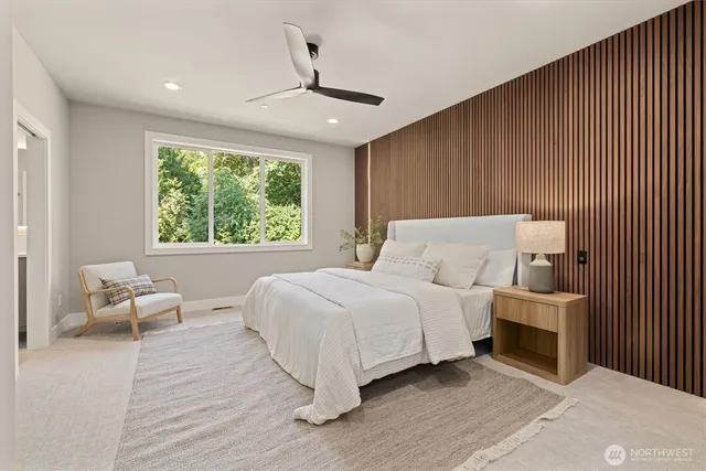 a bedroom with a bed and a large window