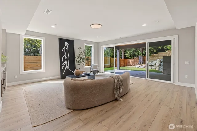 a living room with furniture and large windows