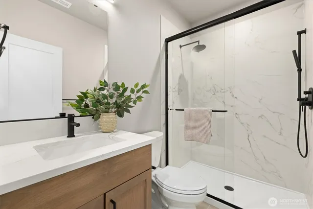 a bathroom with a sink toilet and shower
